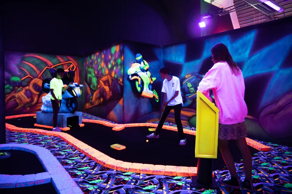 Kinderen spelen neon minigolf bij PlazaSportz Assen